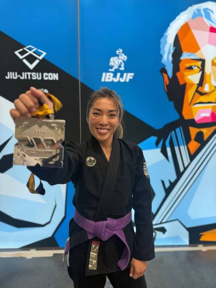 Coco with a jiu jitsu medal