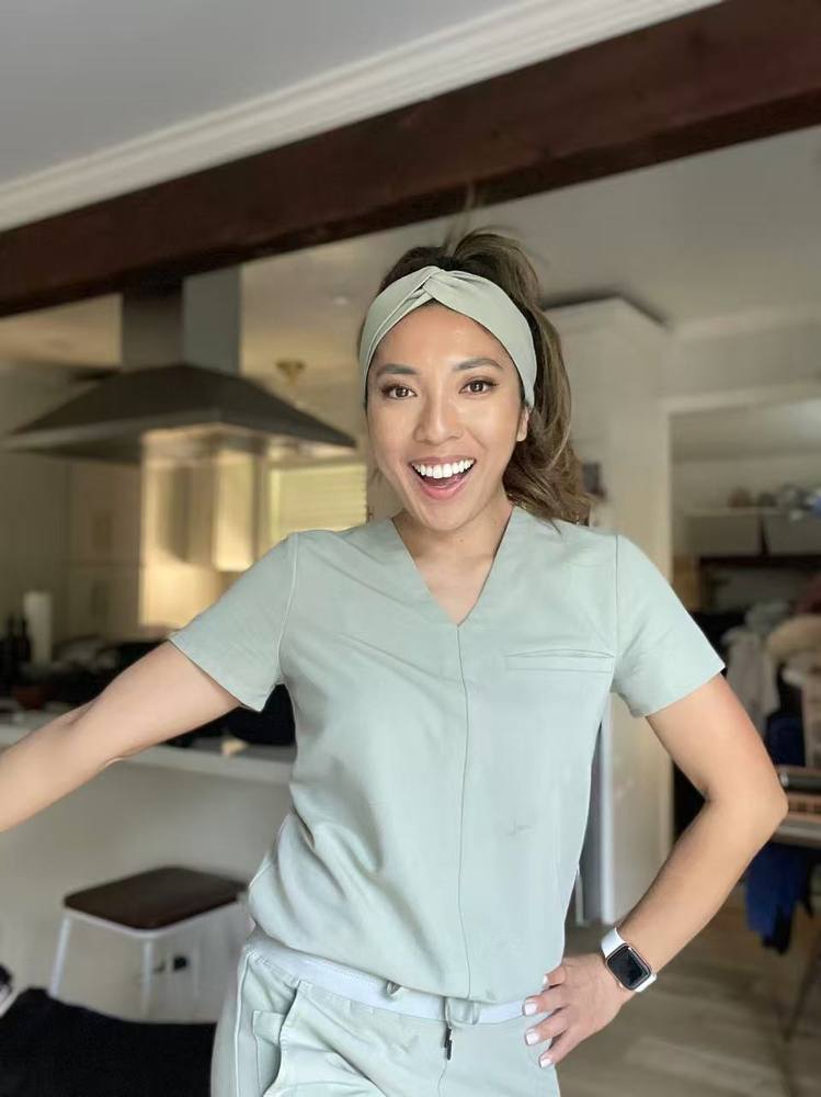 Coco at home in sage scrubs