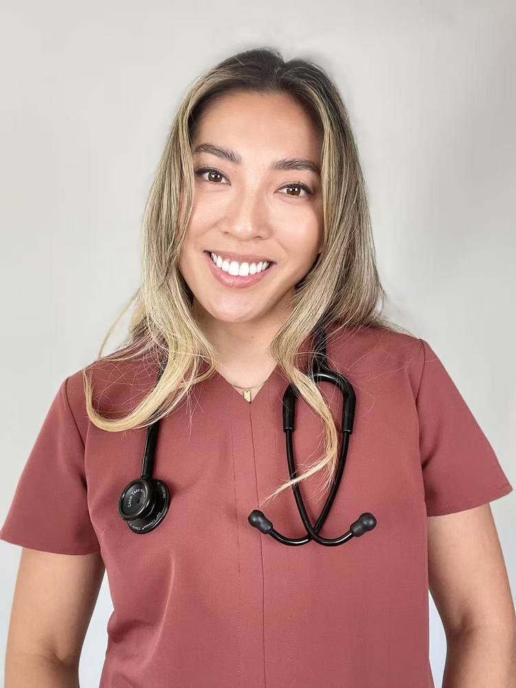 Coco in CORY scrubs with a stethoscope
